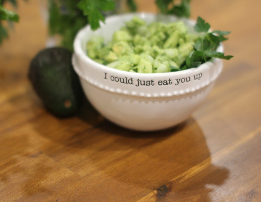 close up picture of apple guacamole in a white bowl