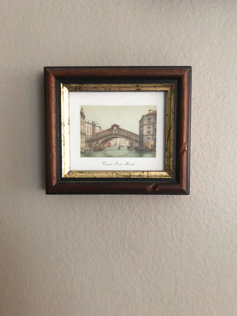 small wooden frame with a picture of a bridge in Venice, Italy.