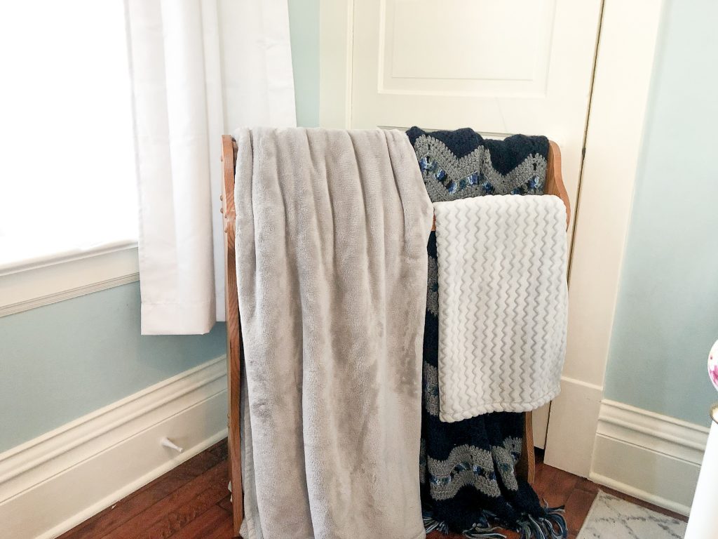 blanket rack with gray and blue blankets